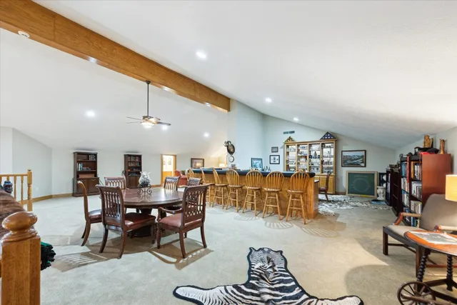 a kitchen with a dining table chairs refrigerator and cabinets