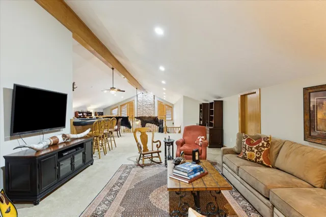 a bathroom with a granite countertop sink a mirror and a shower