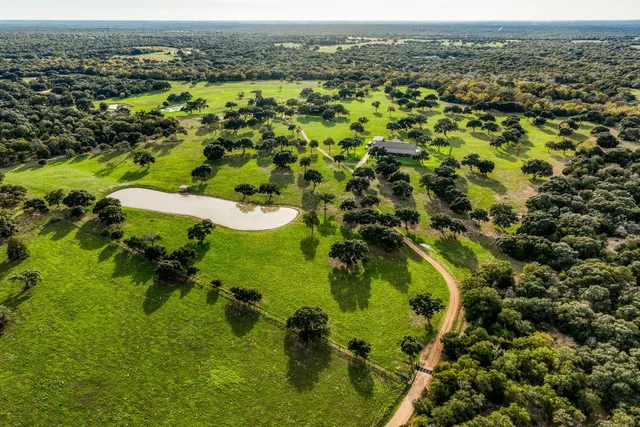 a view of a swimming pool with a patio and a yard
