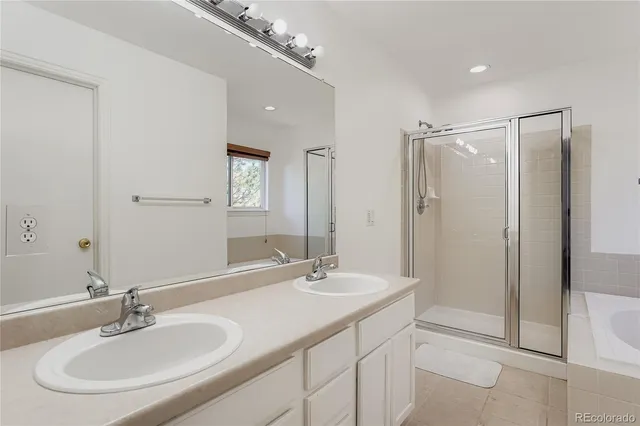 a bathroom with a sink shower and a mirror