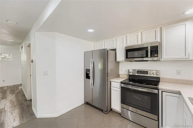 a kitchen with a refrigerator stove and microwave