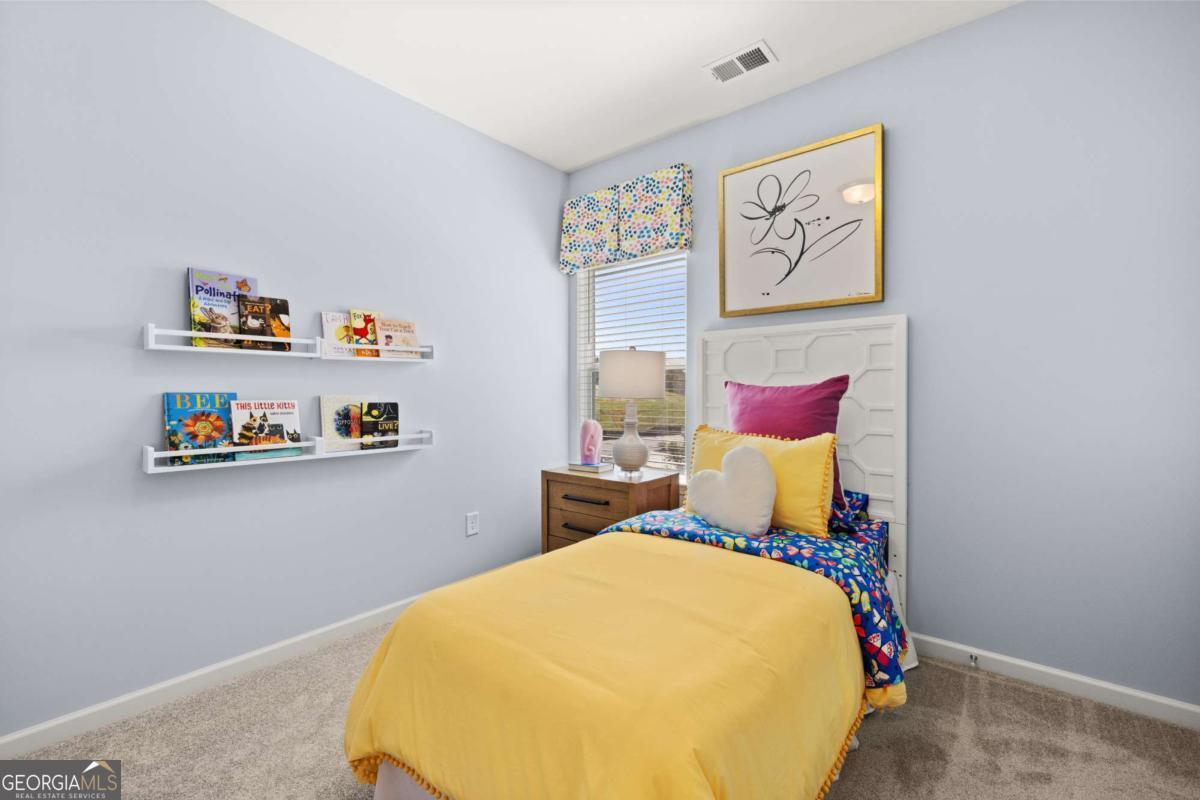 234 Shantz Way, Unit (LOT A34) Byron, GA 31008 - Photo 21 of 23 a bedroom with a bed and painting on the wall