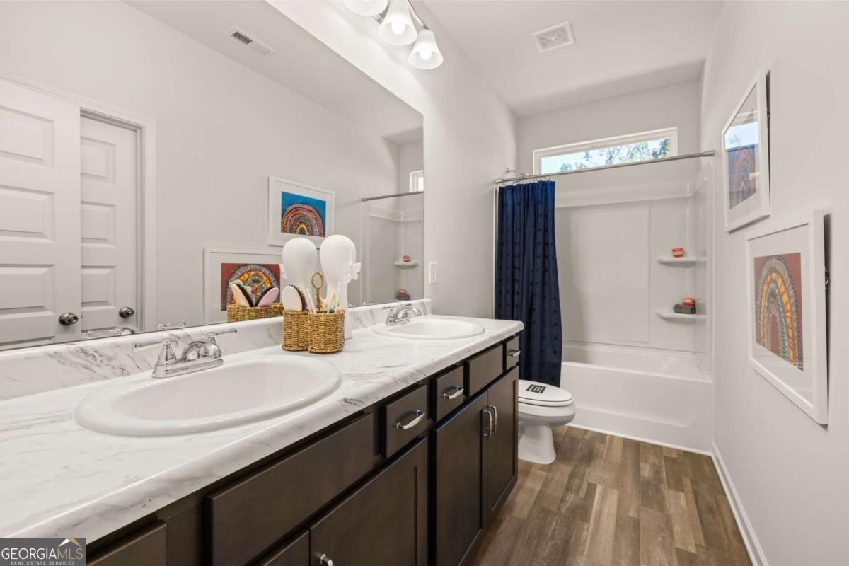 234 Shantz Way, Unit (LOT A34) Byron, GA 31008 - Photo 22 of 23 a bathroom with a granite countertop sink a toilet and shower