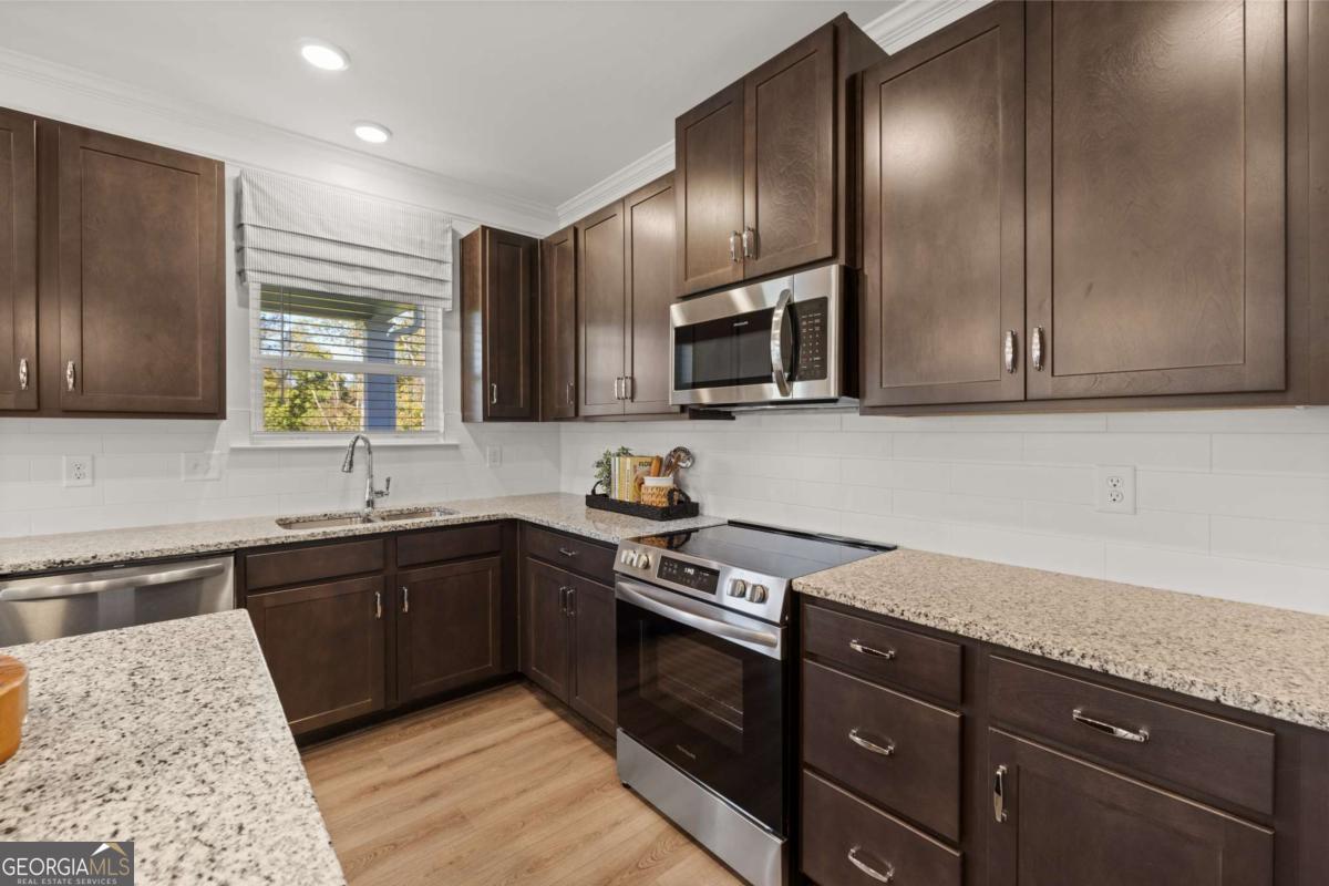 234 Shantz Way, Unit (LOT A34) Byron, GA 31008 - Photo 6 of 23 a kitchen with granite countertop wooden cabinets stainless steel appliances and a sink