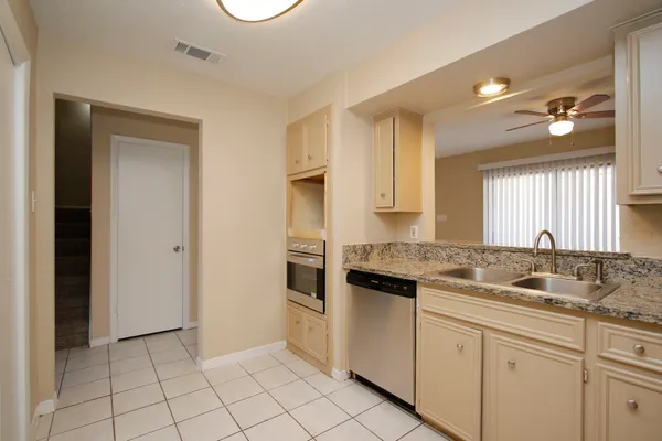 an empty room with fan and windows