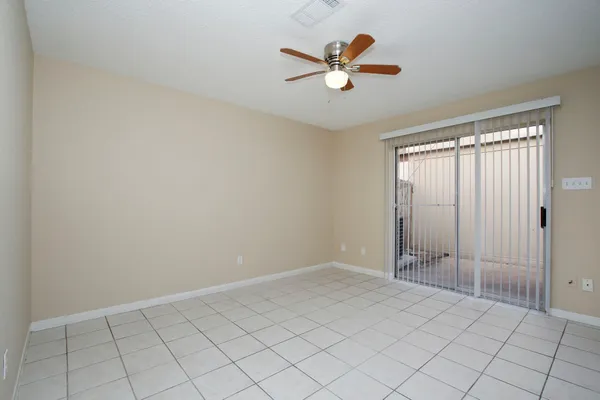 an empty room with closet and windows