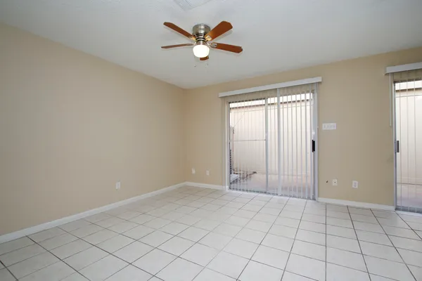 a view of a livingroom with a ceiling fan and window