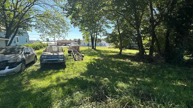 a backyard of a house with fountain table and chairs