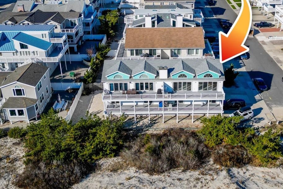 12 82nd Street, Unit NORTH Sea Isle City, NJ 08243 - Photo 2 of 26 an aerial view of multiple houses with a yard