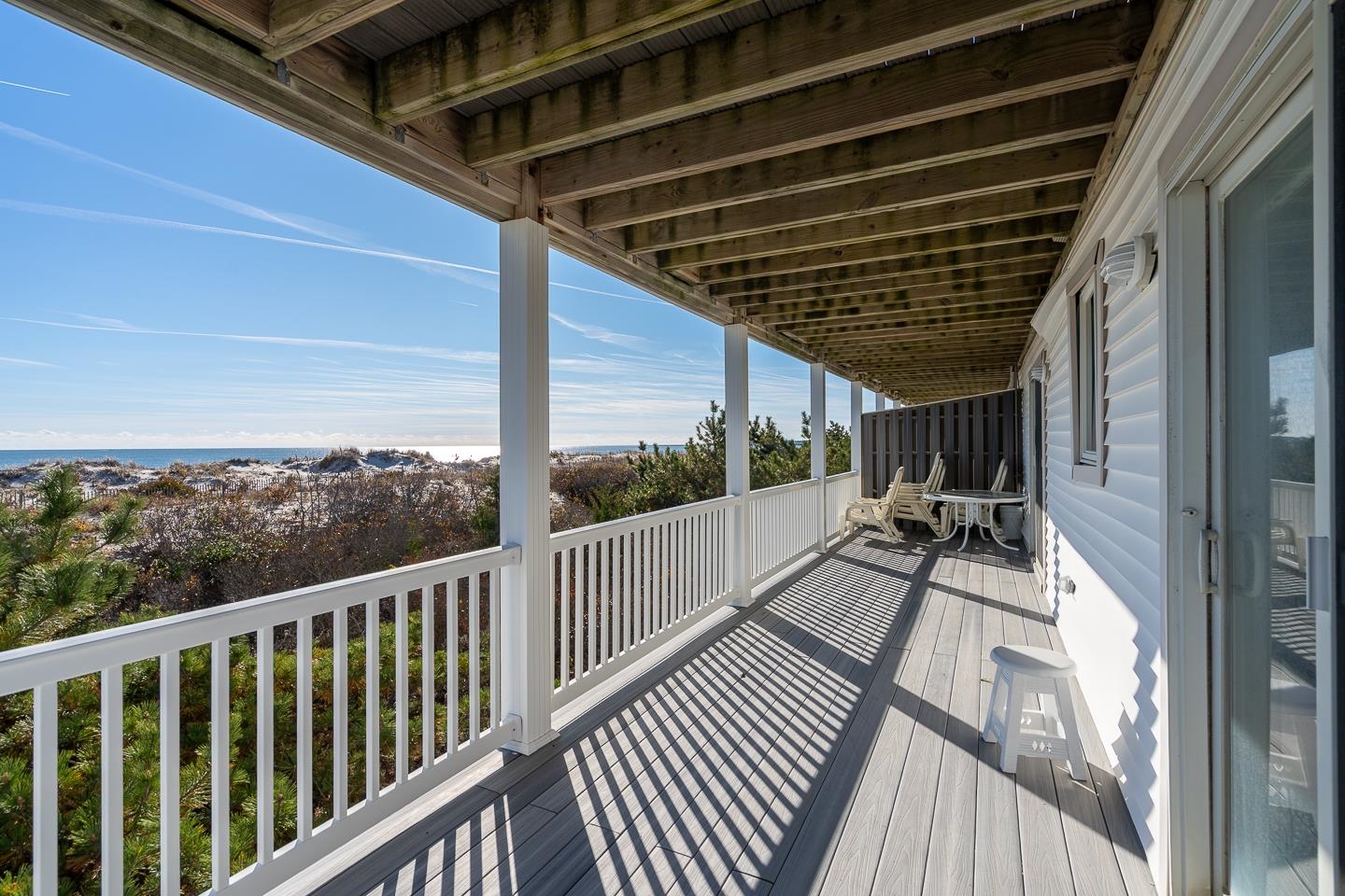 12 82nd Street, Unit NORTH Sea Isle City, NJ 08243 - Photo 21 of 26 a view of a balcony with chairs and wooden floor