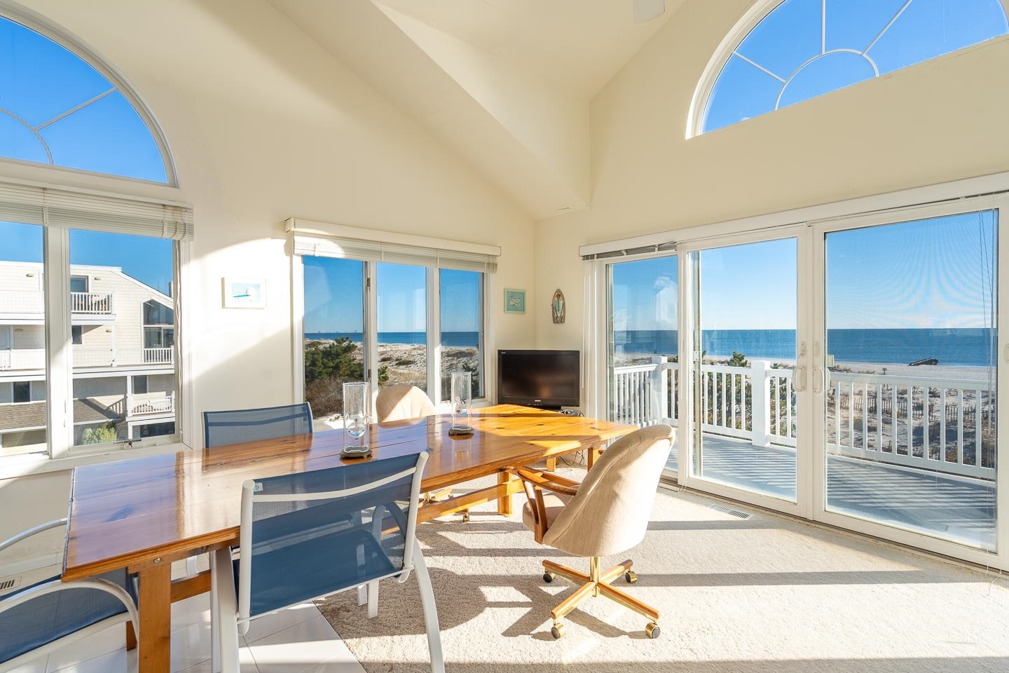 12 82nd Street, Unit NORTH Sea Isle City, NJ 08243 - Photo 7 of 26 a outdoor space with patio the couches and a dining table under an umbrella