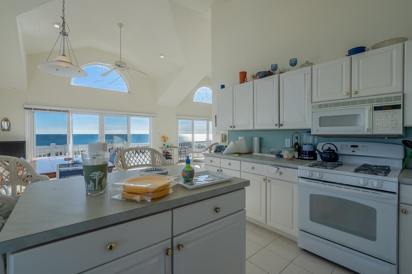 12 82nd Street, Unit NORTH Sea Isle City, NJ 08243 - Photo 10 of 26 a kitchen with a sink dishwasher and white cabinets with wooden floor