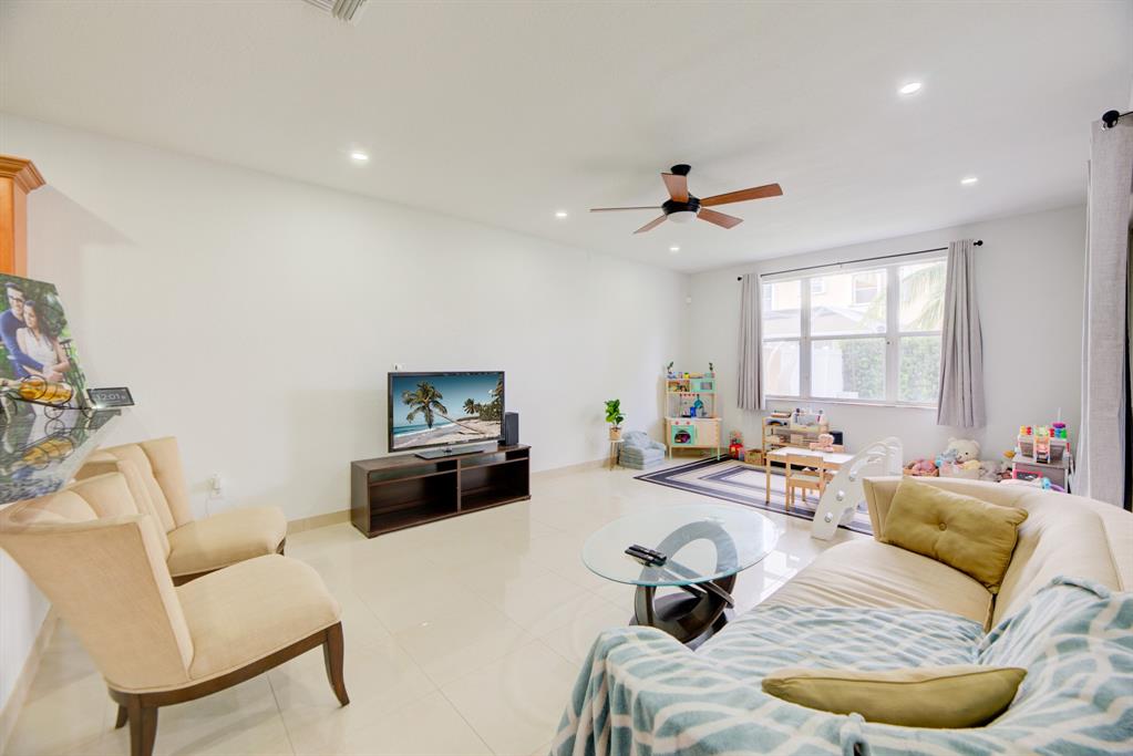 724 Northwest 155th Terrace Pembroke Pines, FL 33028 - Photo 14 of 46 a living room with furniture couches and a flat screen tv
