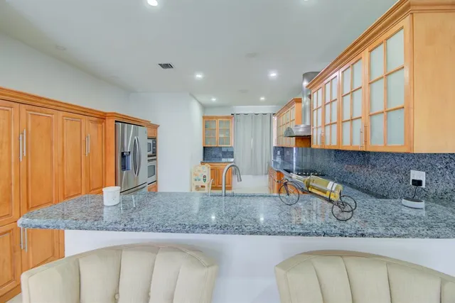a kitchen with a sink a counter top space and cabinets