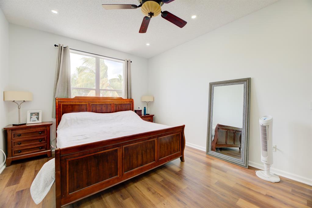 724 Northwest 155th Terrace Pembroke Pines, FL 33028 - Photo 22 of 46 a bedroom with a bed and wooden floor