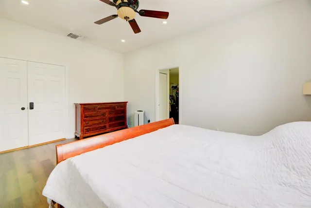 a bedroom with a bed and dresser