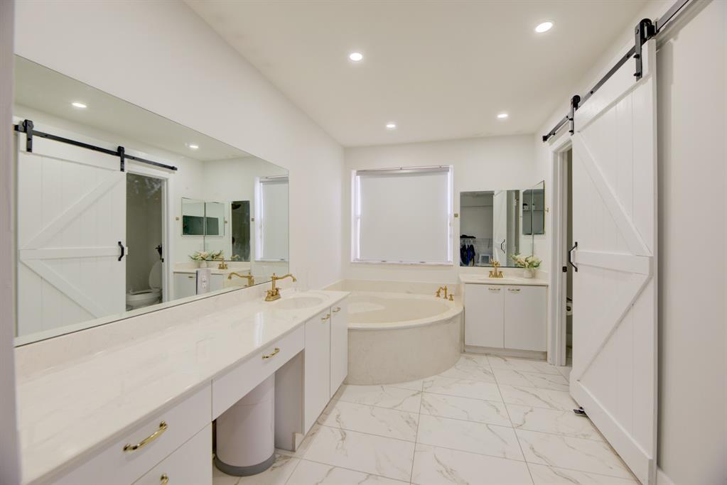 724 Northwest 155th Terrace Pembroke Pines, FL 33028 - Photo 24 of 46 a large white bathroom with a large mirror vanity shower and bathtub