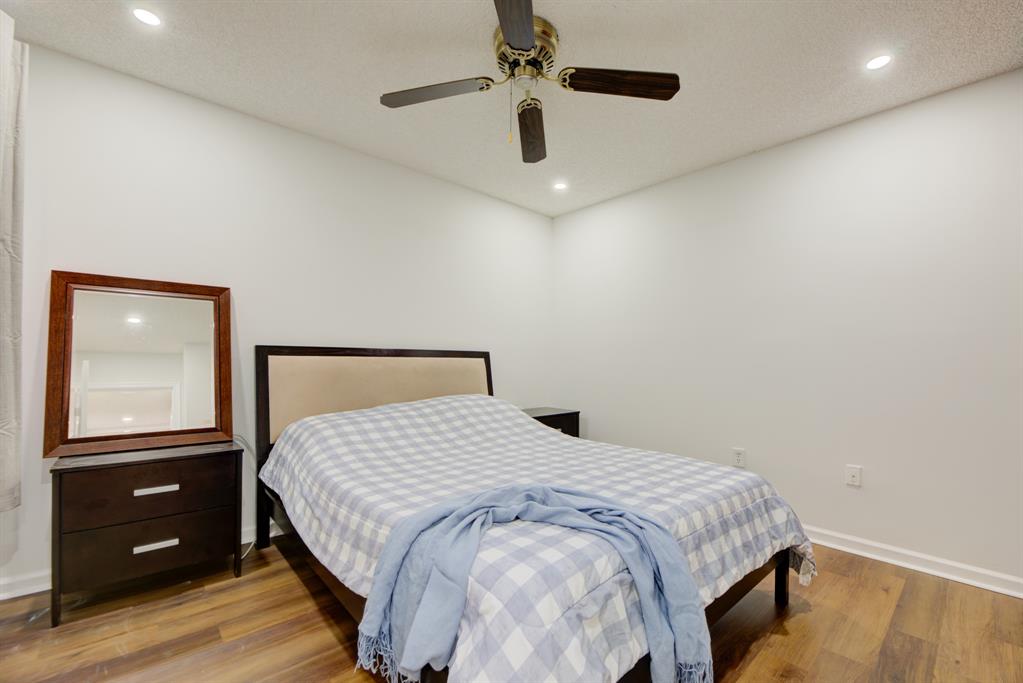 724 Northwest 155th Terrace Pembroke Pines, FL 33028 - Photo 28 of 46 a bedroom with a large bed and a dresser