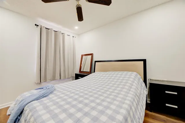 a large bed sitting in a bedroom next to a window