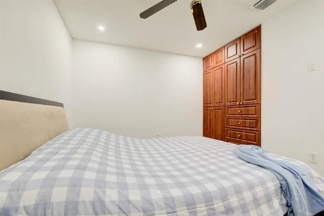 a bedroom with a large bed and a chandelier