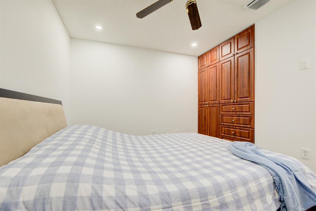 724 Northwest 155th Terrace Pembroke Pines, FL 33028 - Photo 30 of 46 a bedroom with a large bed and a chandelier