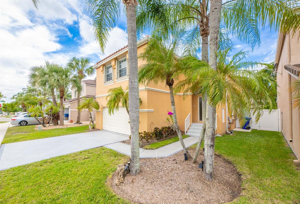 724 Northwest 155th Terrace Pembroke Pines, FL 33028 - Photo 3 of 46 a view of a backyard with a garden