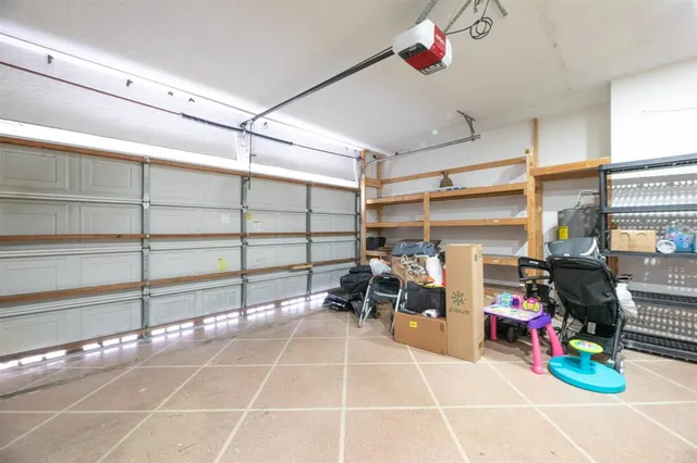 a room with lots of white furniture and a chandelier