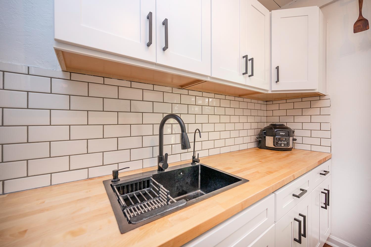 6141 Sweeney Road Somerset, CA 95684 - Photo 26 of 67 a close view of a sink a faucet and appliance in the kitchen