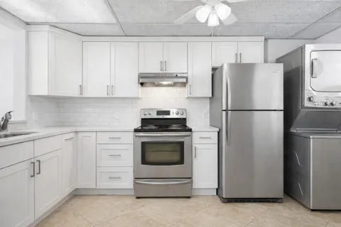 a kitchen with cabinets stainless steel appliances and a counter space