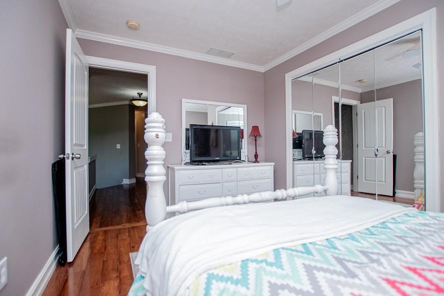 575 Liberty Church Road Carrollton, GA 30116 - Photo 44 of 95 a bedroom with a bed and a large mirror in it