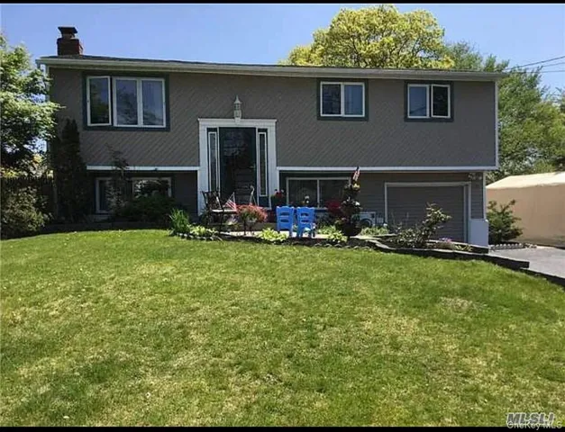 a backyard of a house with yard table and chairs