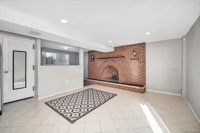 a view of a livingroom with wooden floor and a fireplace