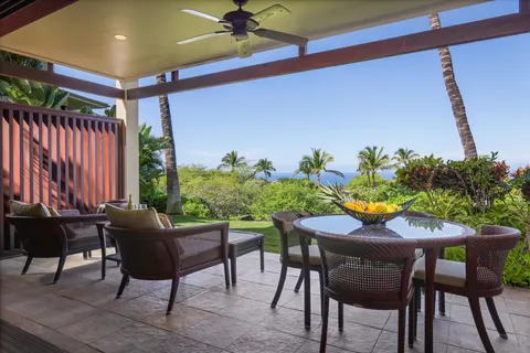 a view of a patio with table and chairs and potted plants