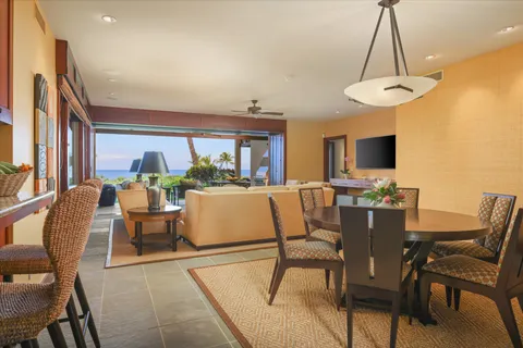 a dining room with furniture a chandelier and a rug