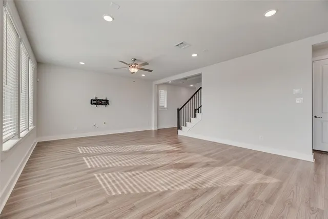 a kitchen with stainless steel appliances granite countertop a sink and a large window