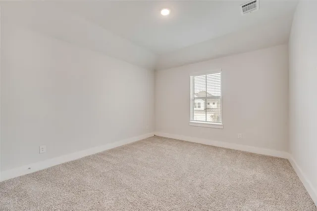 an empty room with a kitchen and a sink