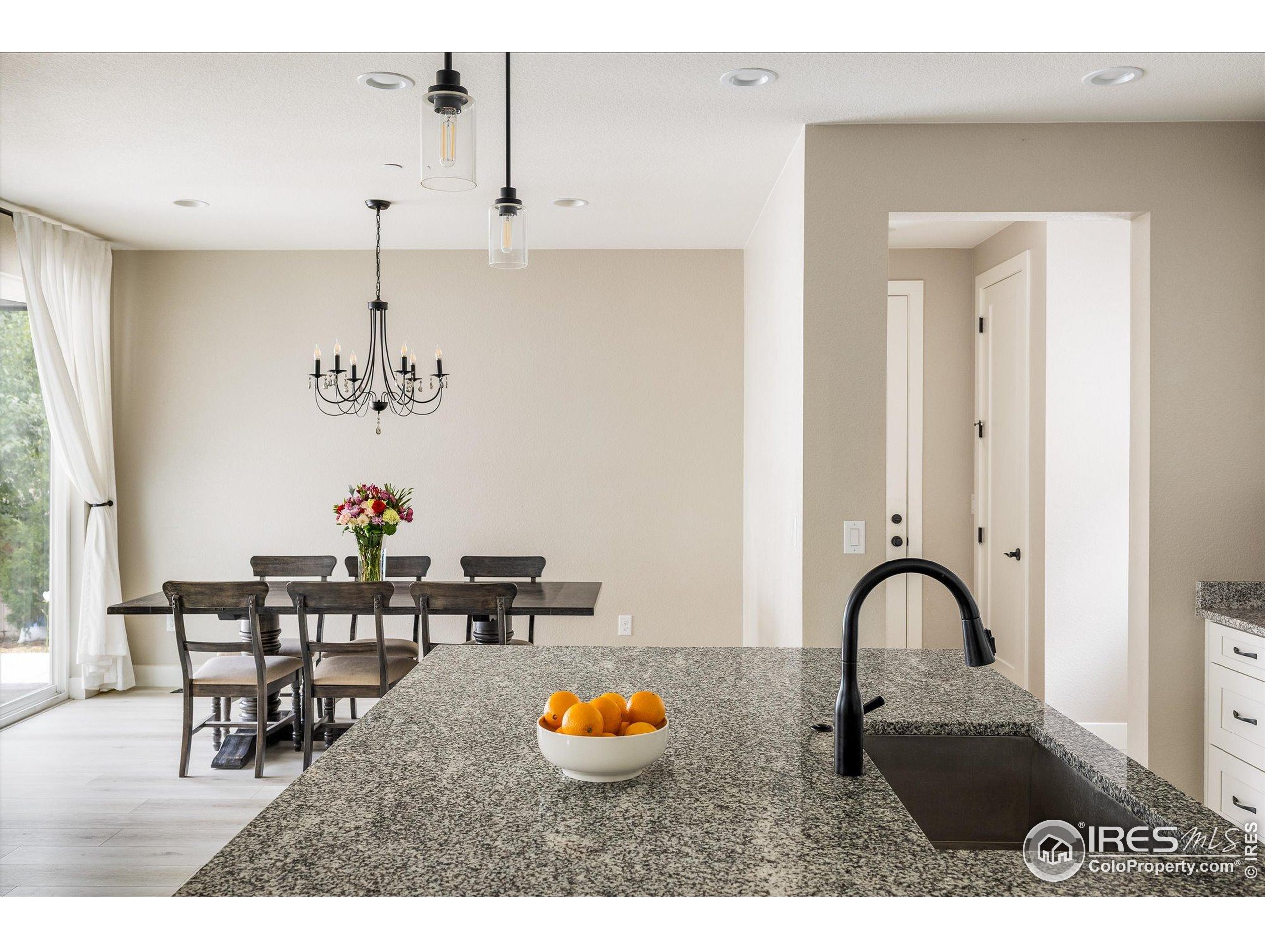 10121 Flower Street Westminster, CO 80021 - Photo 12 of 40 a view of dining room and hall with dining table and appliances