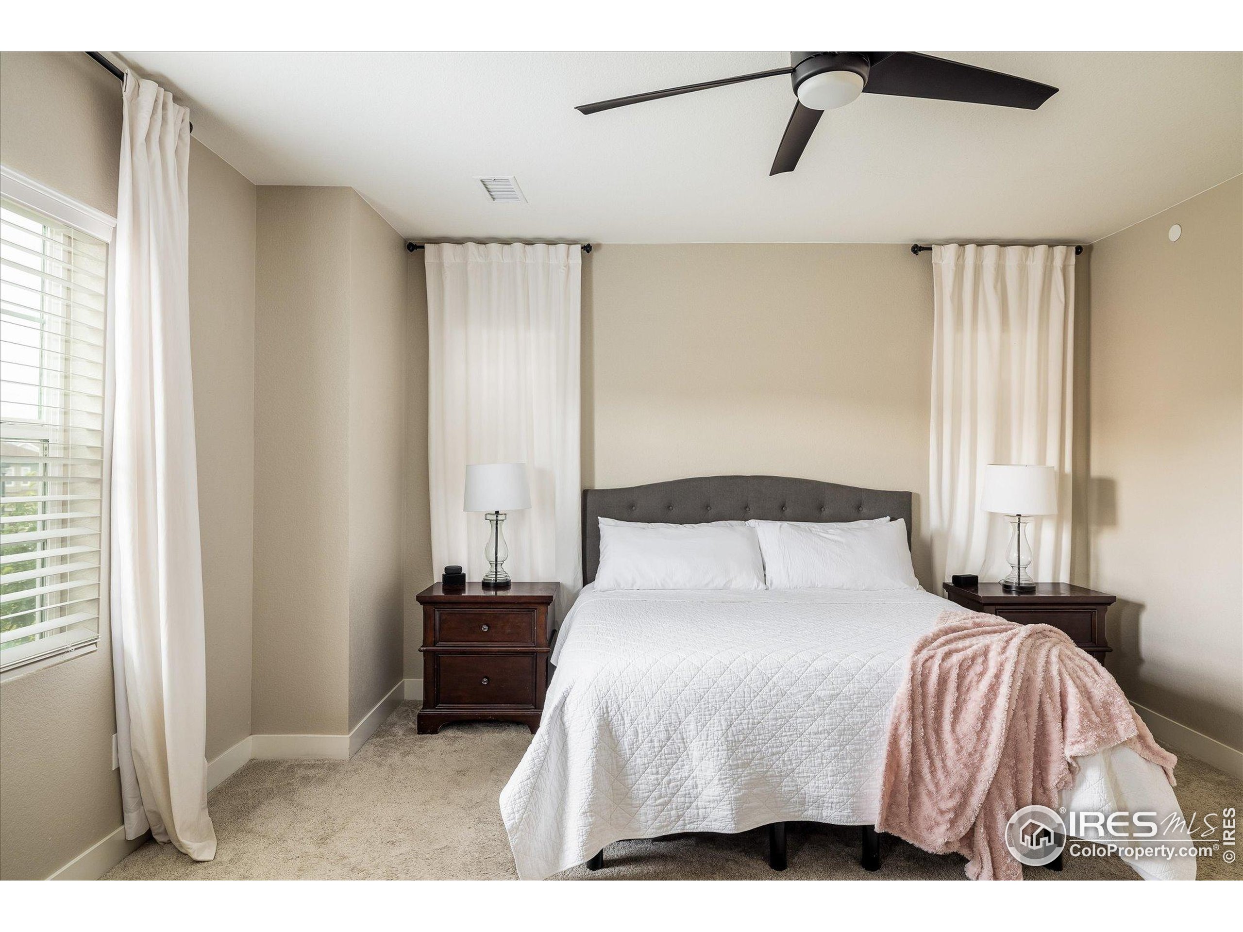 10121 Flower Street Westminster, CO 80021 - Photo 19 of 40 a bedroom with a bed and a window