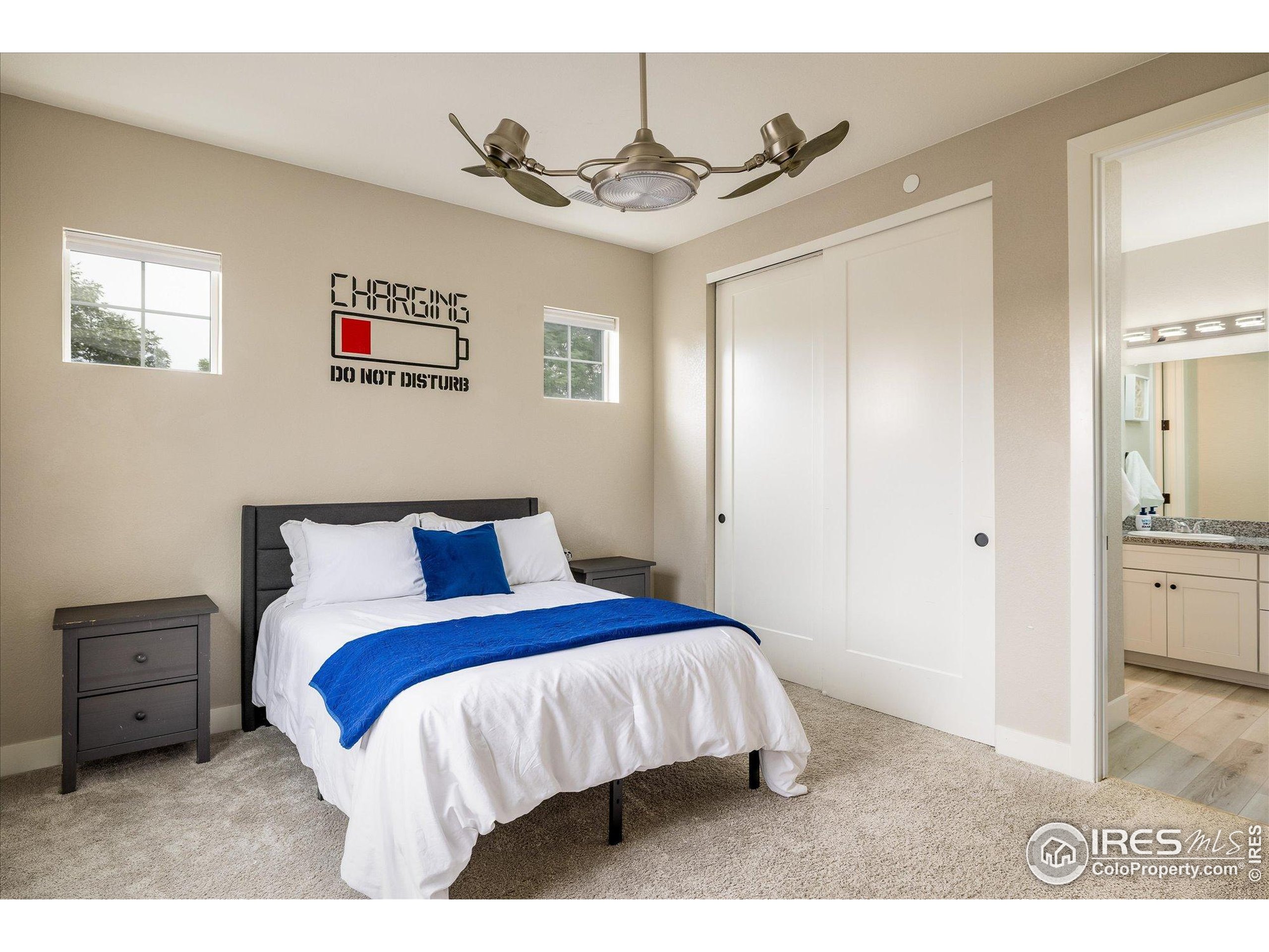10121 Flower Street Westminster, CO 80021 - Photo 24 of 40 a bedroom with a bed and a view of kitchen