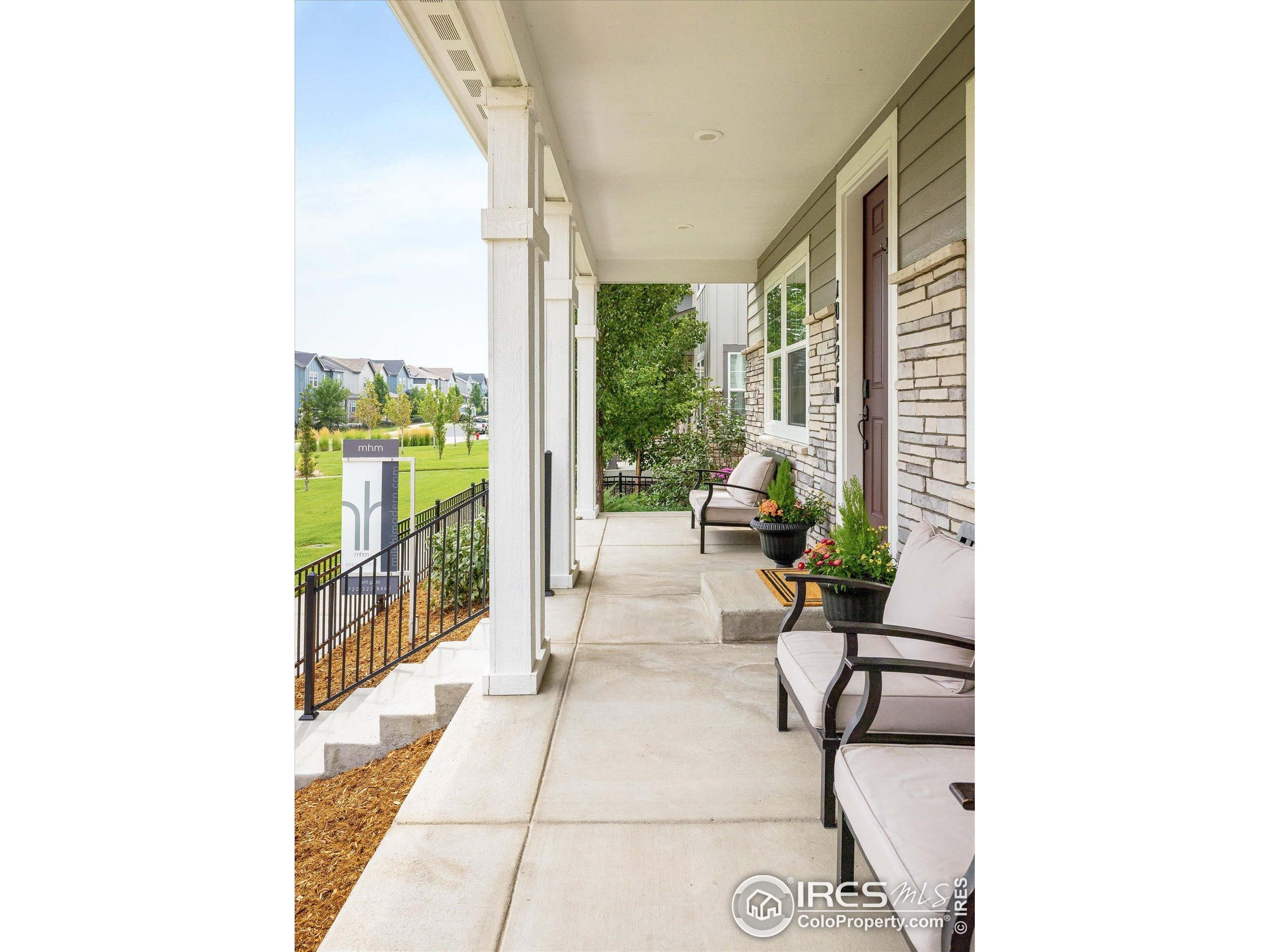 10121 Flower Street Westminster, CO 80021 - Photo 5 of 40 a living room with furniture and a floor to ceiling window