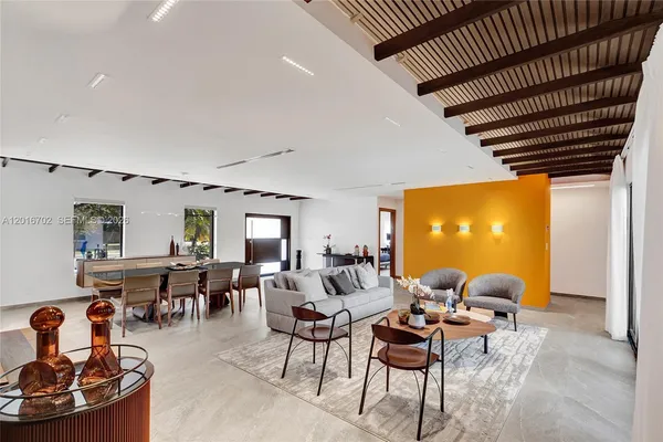a living room with lots of furniture and a large window