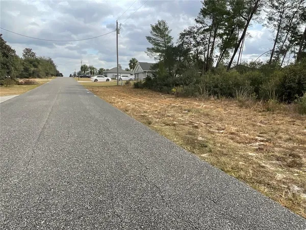a view of a road with a building in the background