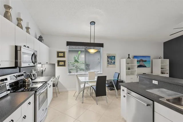a kitchen with stainless steel appliances a sink stove and refrigerator