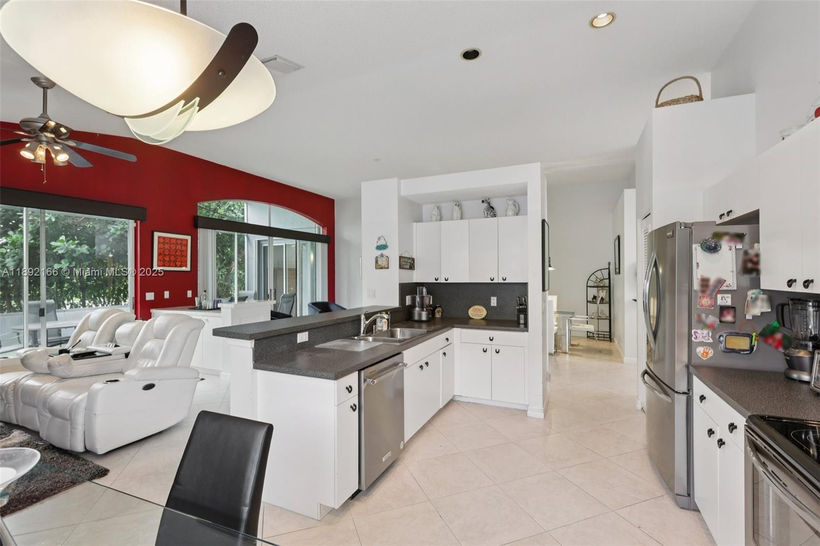 8752 Northwest 75th Court Tamarac, FL 33321 - Photo 13 of 26 a kitchen with stainless steel appliances a sink stove and refrigerator
