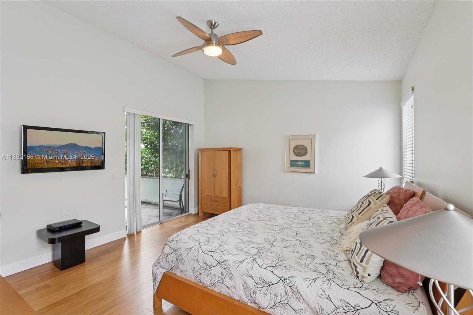 8752 Northwest 75th Court Tamarac, FL 33321 - Photo 15 of 26 a bedroom with a bed and a view of bedroom