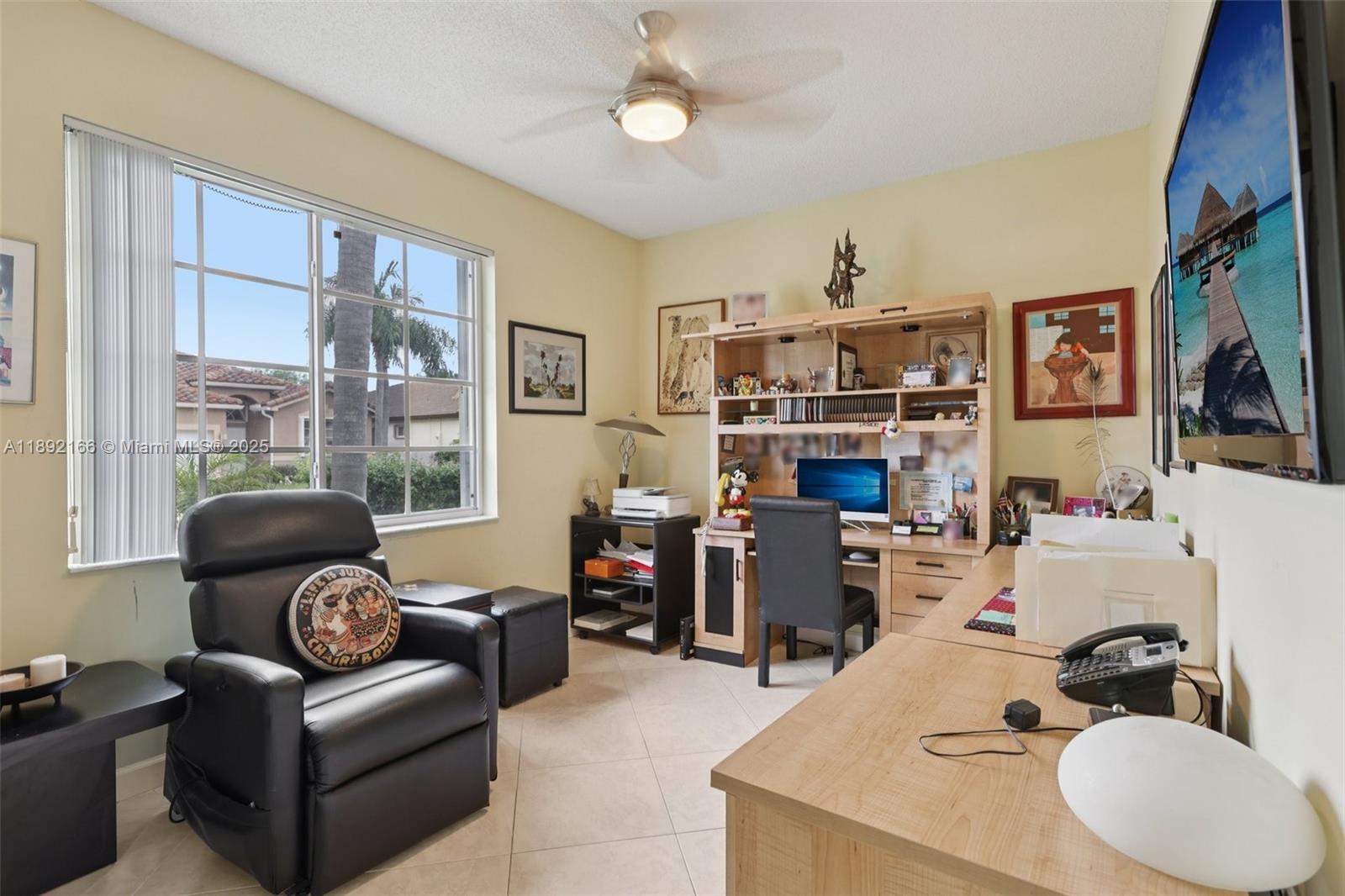 8752 Northwest 75th Court Tamarac, FL 33321 - Photo 21 of 26 a living room with furniture and a fireplace
