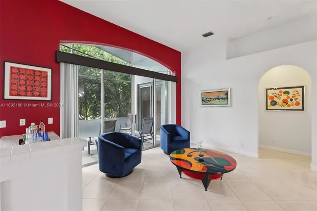 a living room with furniture a rug and a large window