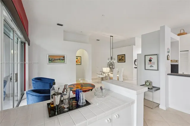 a living room with furniture and kitchen view