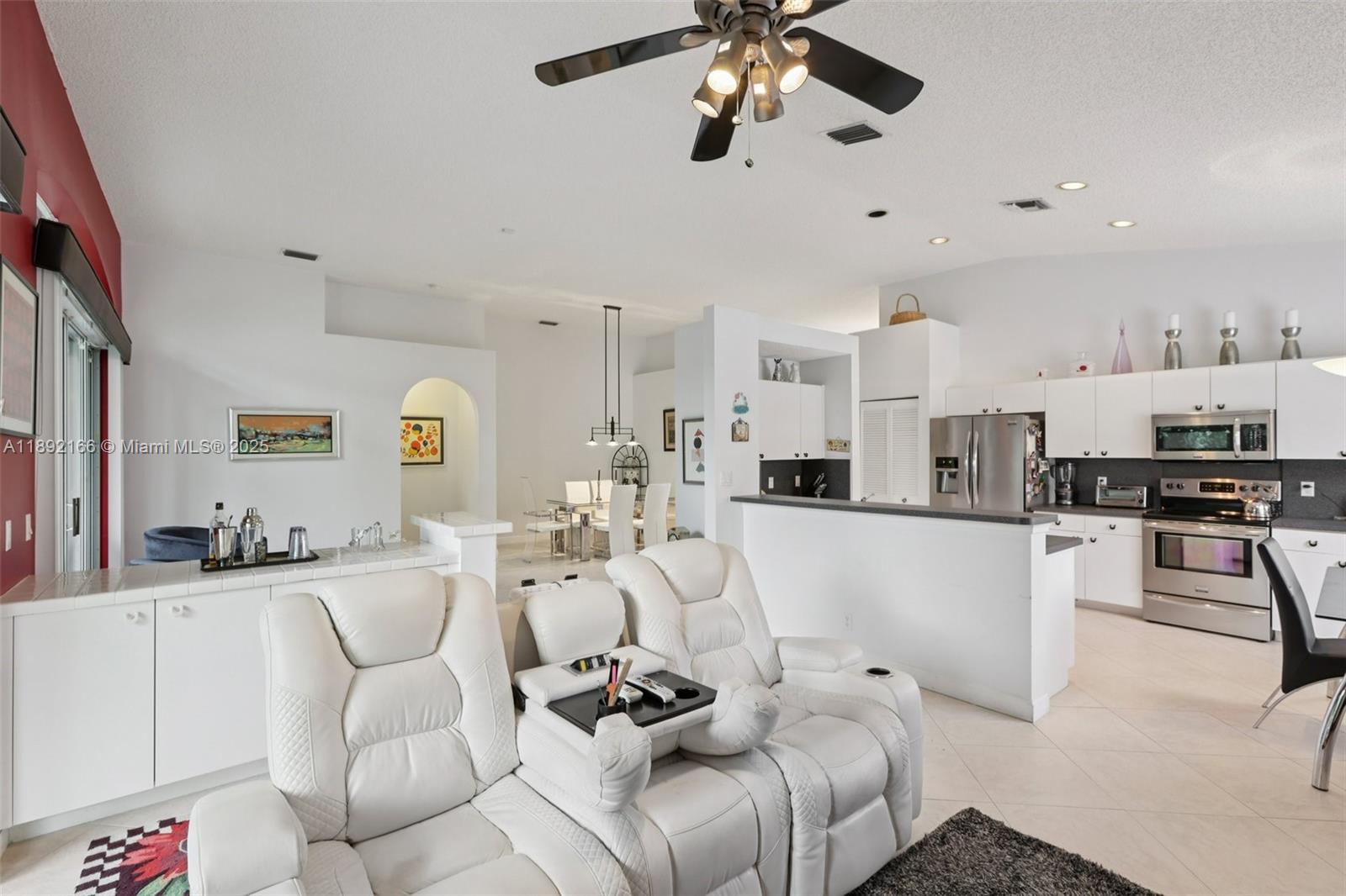 8752 Northwest 75th Court Tamarac, FL 33321 - Photo 9 of 26 a living room with furniture and kitchen view