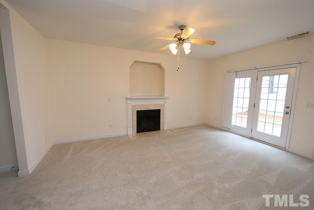 6020 Brambleberry Way Raleigh, NC 27616 - Photo 2 of 14 Family Room features gas fireplace and door to patio and fenced back yard.